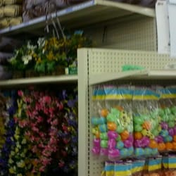 Easter eggs and lawn chair cushions and plastic flowers! Behind me paper towels and bleach and mascara! Huh?