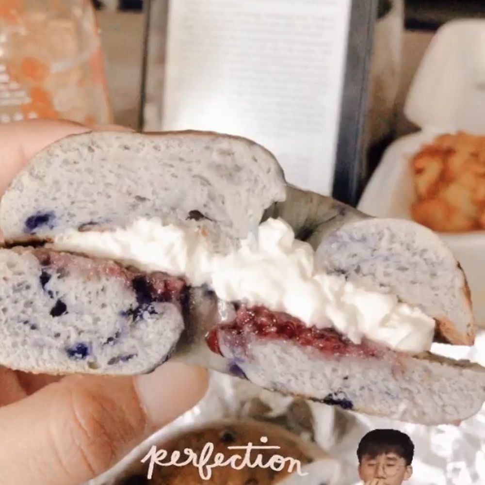 Blueberry bagel with cream cheese and grape jelly Blueberry bagel with cream cheese and grape jelly