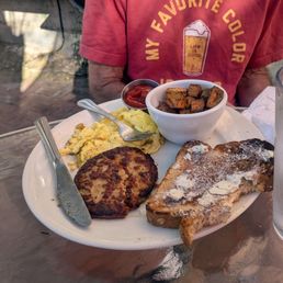 Scrambled eggs, patty sausage. Toast, potatoes