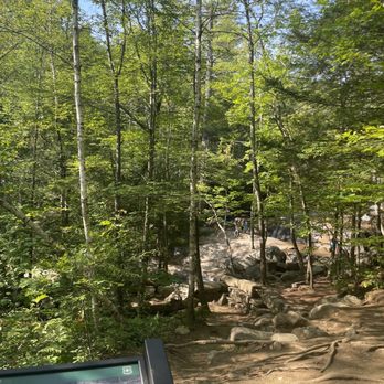 Diana's Baths - A forest trail with rocks and trees, leading towards a water feature at Diana's Baths in Bartlett, New Hampshire. - Landmarks & Historical Buildings Near Me - Bartlett, New Hampshire