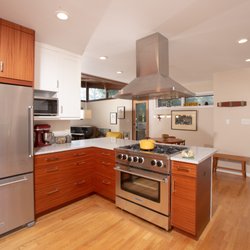 Merrick Design and Build - This two tone kitchen features custom sapele cabinets with continuous grain, white upper cabinets and new stainless steel appliances.