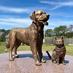 Dulaney Valley Pet Loss Center - Bronze life size dog and cat atop cremation niches in Pet Sanctuary garden.