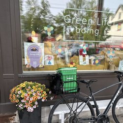 Green Life Trading Company - A bike with a Green Box Compost bucket in tow parked outside Green Life Trading Co. on Williamson Street in Madison, Wisconsin.