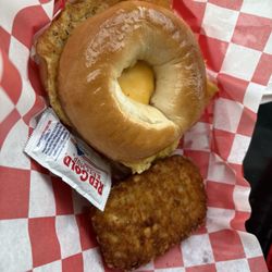 Egg and cheese on plain bagel with hash brown