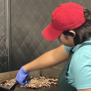 Martinez Tacos - a woman preparing food in a kitchen - Tacos Near Me - Hebron, Kentucky