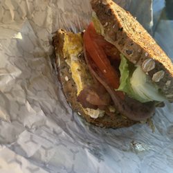 Six Gun Charlies - The Breakfast Sandwich with egg, bacon, bologna, crispy lettuce, fresh tomato, light mayo on perfectly toasted whole wheat bread.
