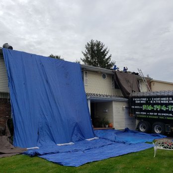 CDC Roofing & Contracting - The house and grounds are being protected with tarps. On this job 99% of the old roofing went directly into the truck. - Roofing Near Me - Levittown, New York