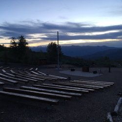Heber Valley Camp - Amphitheater near the camp entrance for gatherings, meetings, and firesides, overlooking the Heber valley at dusk.