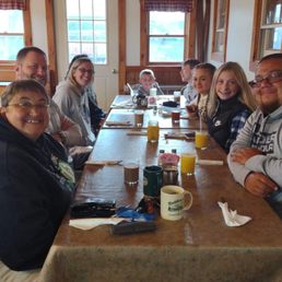 a group of people sitting at a table a group of people sitting at a table