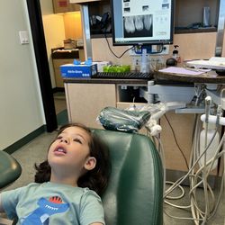 Westchester Pediatric Dentistry - Exam room with TV above chair so kids can relax and watch while they get their cleaning done.