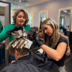 Triniti Salon & HeadSpa - Stylists working together on highlights.