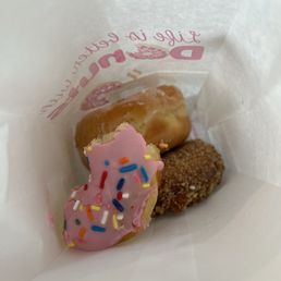 two donuts with pink frosting and sprinkles