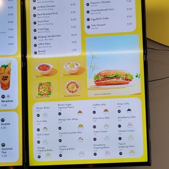 Tealux Cafe - A digital menu board shows various sandwiches and street food items, including prices, with colorful icons and images of some dishes. - Bubble Tea Near Me - Ballwin, Missouri
