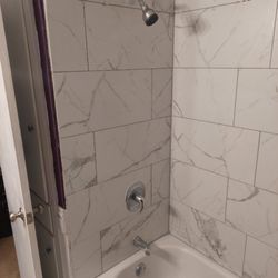 D-N-A Home Remodeling and Repairs - Bathtub surround tiled with new fixtures