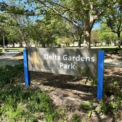 Delta Gardens Park - Signage with part of the park in the background