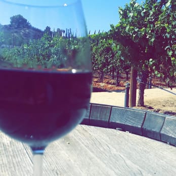 Leoness Cellars - enjoying a glass of wine in the vine yard - Venues & Event Spaces Near Me - Temecula, California