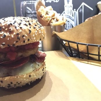 Hambrgr - Their smash burger of the week (white cheddar, grilled pineapple, pepperoni, tomato relish) & garlic parm fries in the back. - Burgers Near Me - Hamilton, Ontario