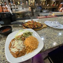 The Texas fajitas with steak, chicken, shrimp, onions peppers and sides The Texas fajitas with steak, chicken, shrimp, onions peppers and sides