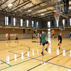 Eugene Family YMCA - Pick-up basketball in the gymnasium. Members can walk the indoor track around the courts