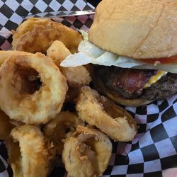 Lercy's Diner - Lercy's bacon cheeseburger: juicy patty, melted cheddar, crispy bacon, lettuce, tomato, mayo on toasted bun. Golden onion rings.