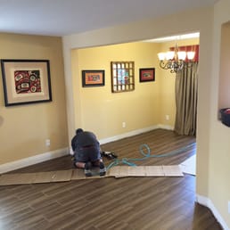 a man working on a hardwood floor a man working on a hardwood floor