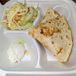 Chicken quesadilla, sour cream and salad