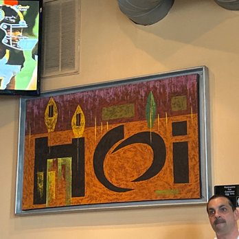 Pancho Pistolas - a man standing in front of a television - Mexican Near Me - Chicago, Illinois