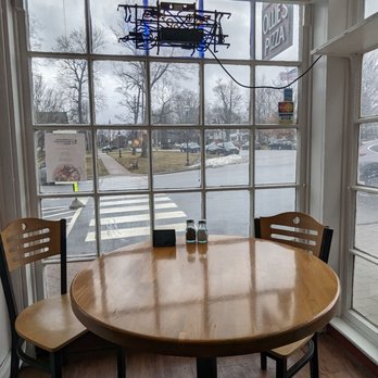 Ollie's Pizza - a table and chairs in front of a window - Pizza Near Me - Litchfield, Connecticut