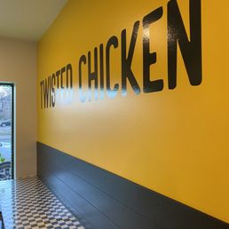 a yellow wall with a black and white checkered floor