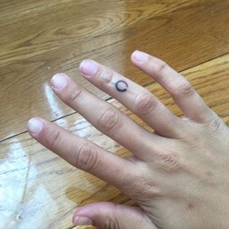 Finger tattoo. There is a bandage on it, hence the sheen. Finger tattoo. There is a bandage on it, hence the sheen.