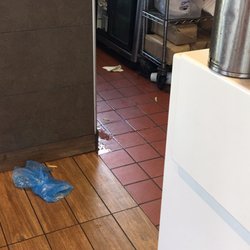 McDonald's - Open cooler door and filthy floor ( I was there 10 minutes and never saw anyone get anything out or close door)