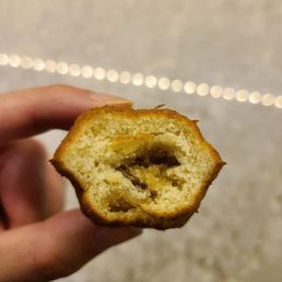 a hand holding a half eaten pastry a hand holding a half eaten pastry