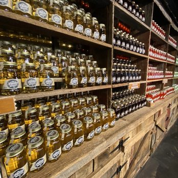 Ole Smoky Distillery "The Barn" - a shelf of jars of liquor - Distilleries Near Me - Pigeon Forge, Tennessee Ole Smoky Distillery "The Barn" - a shelf of jars of liquor - Distilleries Near Me - Pigeon Forge, Tennessee