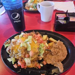 Breakfast chili rellano with scrambled eggs, refried beans, and smothered in green chili. Breakfast chili rellano with scrambled eggs, refried beans, and smothered in green chili.