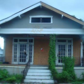 Gray Line New Orleans - Looking at a marked house for evacuation through a rain-soaked bus window - Tours Near Me - New Orleans, Louisiana Gray Line New Orleans - Looking at a marked house for evacuation through a rain-soaked bus window - Tours Near Me - New Orleans, Louisiana