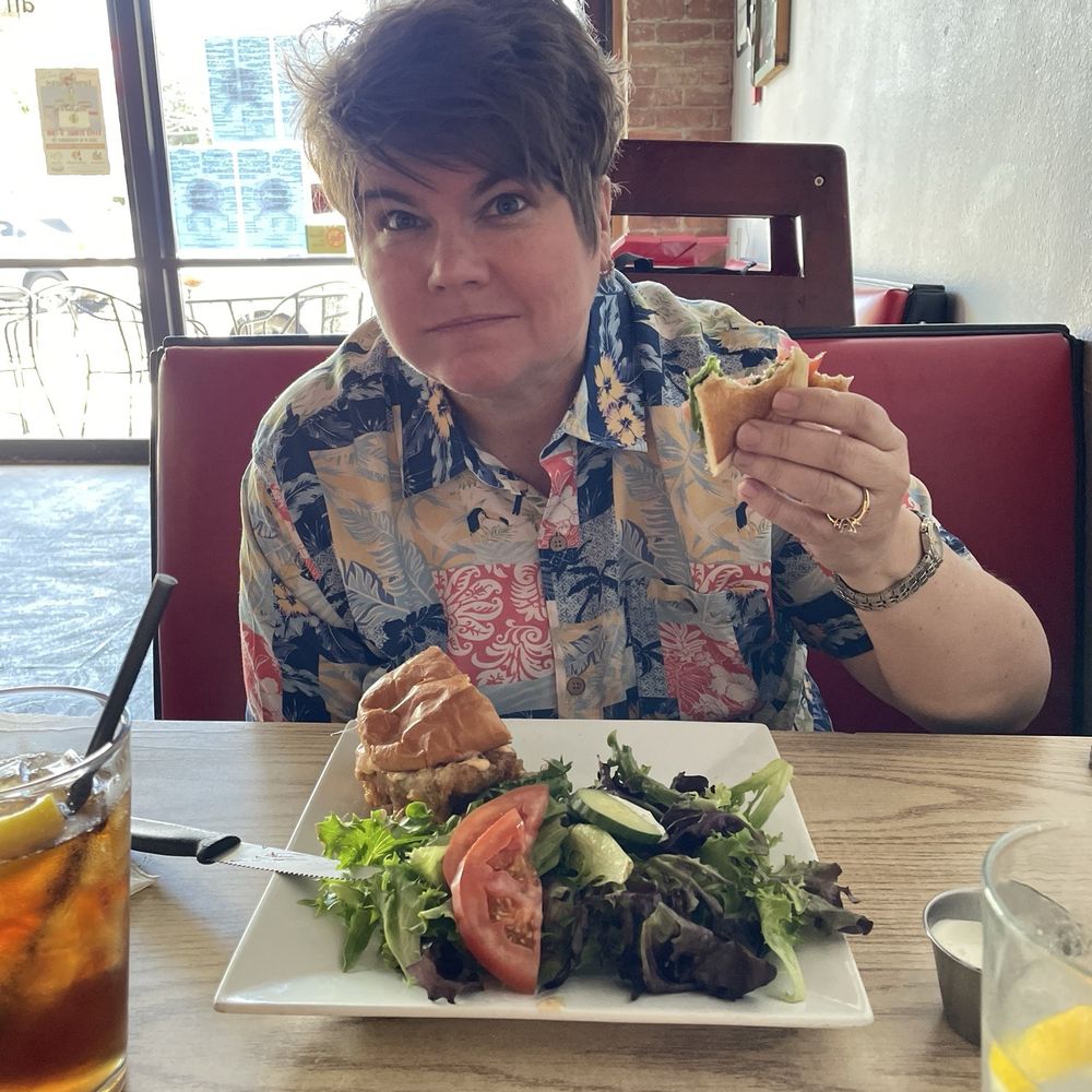 Elliotts an Urban Kitchen - My wife eating the fried chicken sandwich. - New American Near Me - Spokane, Washington Elliotts an Urban Kitchen - My wife eating the fried chicken sandwich. - New American Near Me - Spokane, Washington