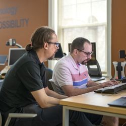 Vision Forward Association - A visually impaired man is being taught how to use the computer by a specialist in an assistive technology class