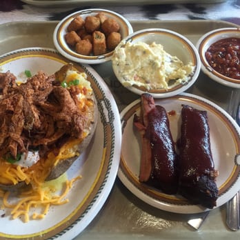 Mike Anderson's BBQ House - Loaded monster potato with pulled pork on top, 2 ribs, fried okra, potato salad and beans. Was sooooo good! - Barbeque Near Me - Dallas, Texas