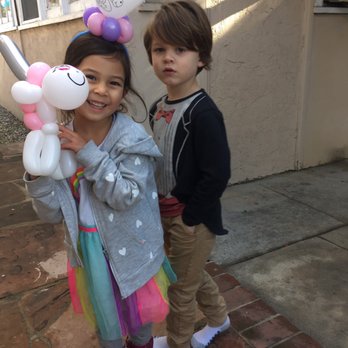 Madcap Balloons - A balloon hairpiece and a unicorn - Balloon Services Near Me