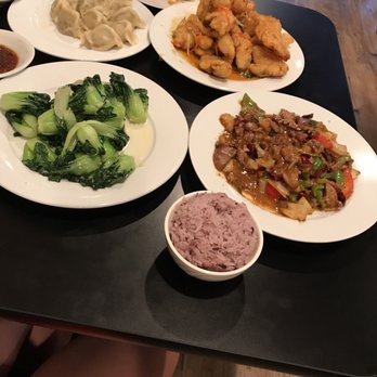 Chin's Kitchen - Purple rice, fried pork slices, sautéed vegetable, various dumplings (one plate was already eaten and off the table), and sautéed kidneys. - Chinese Near Me - Portland, Oregon