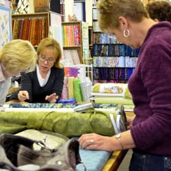 The Quilt Patch - Kathy and Mary, the manager, hash out a customer's pattern issue. In the background, the QP Cube is the home to 2,500 FQs.