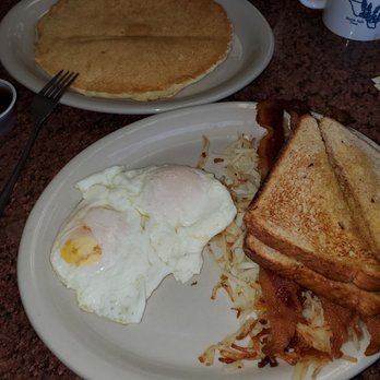 Blue Bonnet Cafe - Two eggs, three bacon, hash browns and toast, and one large pancake! - Desserts Near Me - Marble Falls, Texas