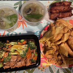 Wonton soup, teriyaki chicken, beef and broccoli, appetizer spread with fried wontons, Crab Rangoon, and egg rolls