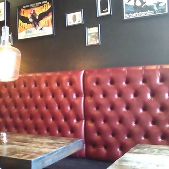 Lucifers Pizza - interior: burgundy faux leather furniture. Dark brown, wooden tables. Unique photos on the walls. - Chicken Wings Near Me - Studio City, California
