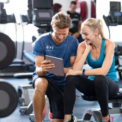 Dedication Fitness - In-person trainer working with their client