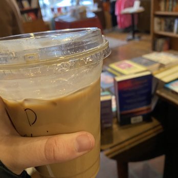 Avant Garden Bookstore  - a hand holding a cup of iced coffee - Coffee & Tea Near Me - Anoka, Minnesota