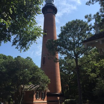 Currituck Beach Lighthouse - A view of the historic lighthouse nestled amongst pines. - Landmarks & Historical Buildings Near Me - Corolla, North Carolina
