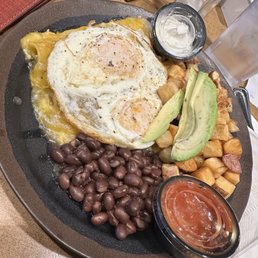 Enchiladas Verdes with eggs, beans, avocado, & potatoes Enchiladas Verdes with eggs, beans, avocado, & potatoes