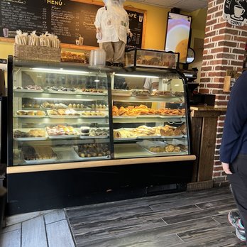 Cortaditos - a woman standing in front of a bakery - Cuban Near Me - Belleville, New Jersey