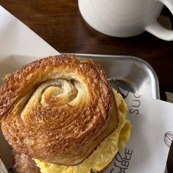 Sucre Table - HONEY CARAMEL BACON, SMOKED GOUDA AND EGG CROISSANT SANDWICH and Cafe con Leche - Bakeries Near Me - Tampa, Florida Sucre Table - HONEY CARAMEL BACON, SMOKED GOUDA AND EGG CROISSANT SANDWICH and Cafe con Leche - Bakeries Near Me - Tampa, Florida